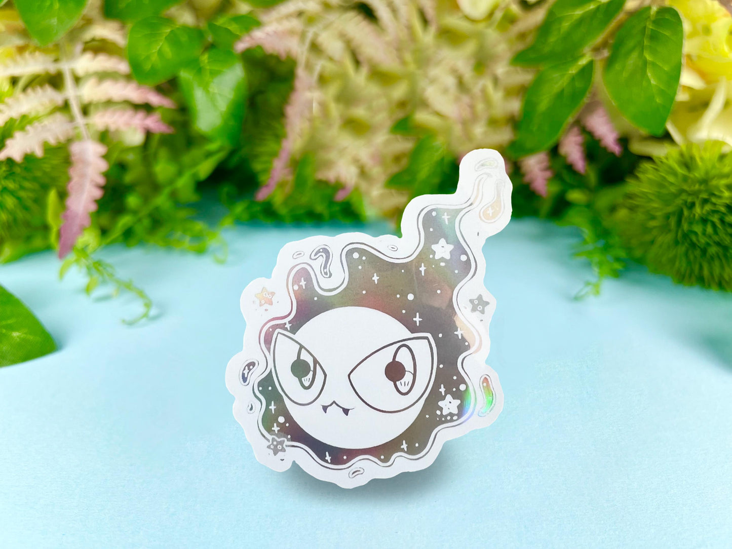 White holographic ghost cloud design with large eyes and sparkles.