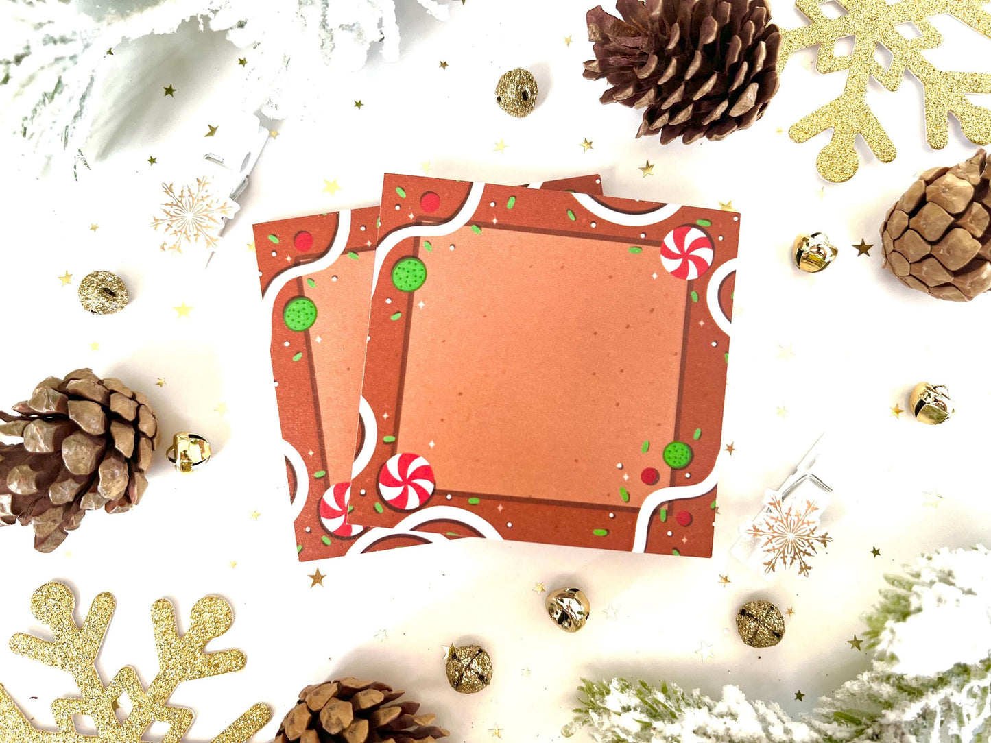 Brown sticky note made to look like a gingerbread house and toppings like red and white peppermints, white frosting, and green/red sprinkles.