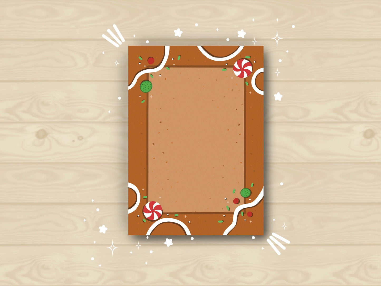 Brown notepad made to look like a gingerbread house and toppings like red and white peppermints, white frosting, and green/red sprinkles.