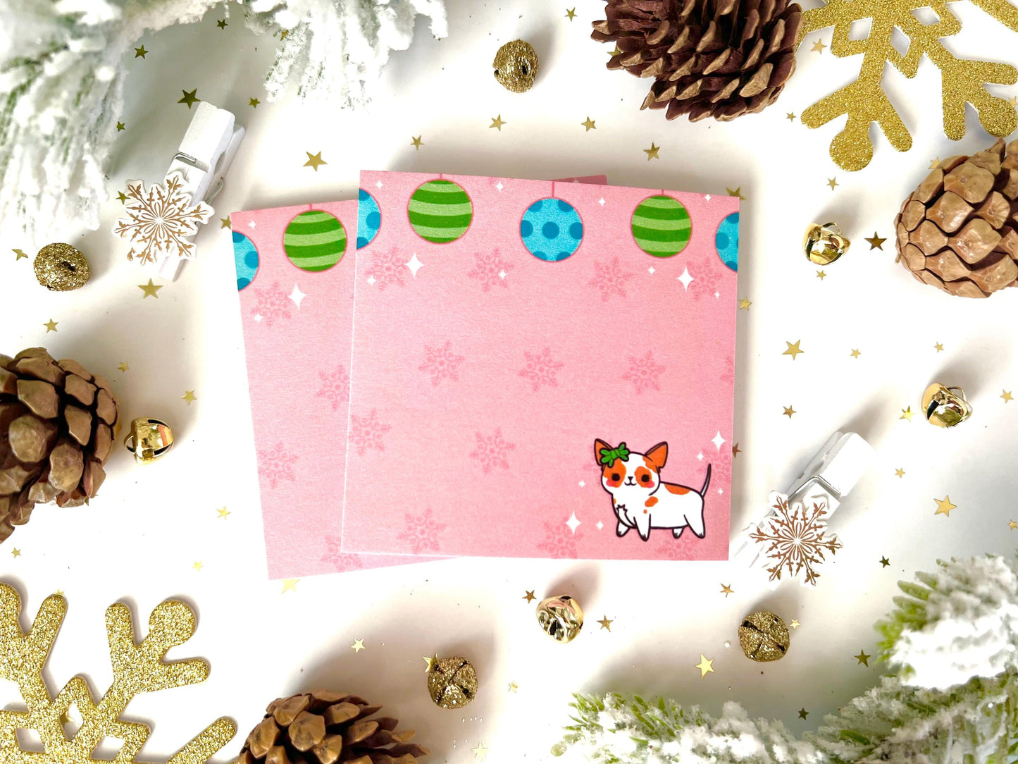 Pink holiday sticky notes with blue and green ornaments hanging from the top, dark pink snowflakes in the background, and a cute dog with a bow walking on the bottom.