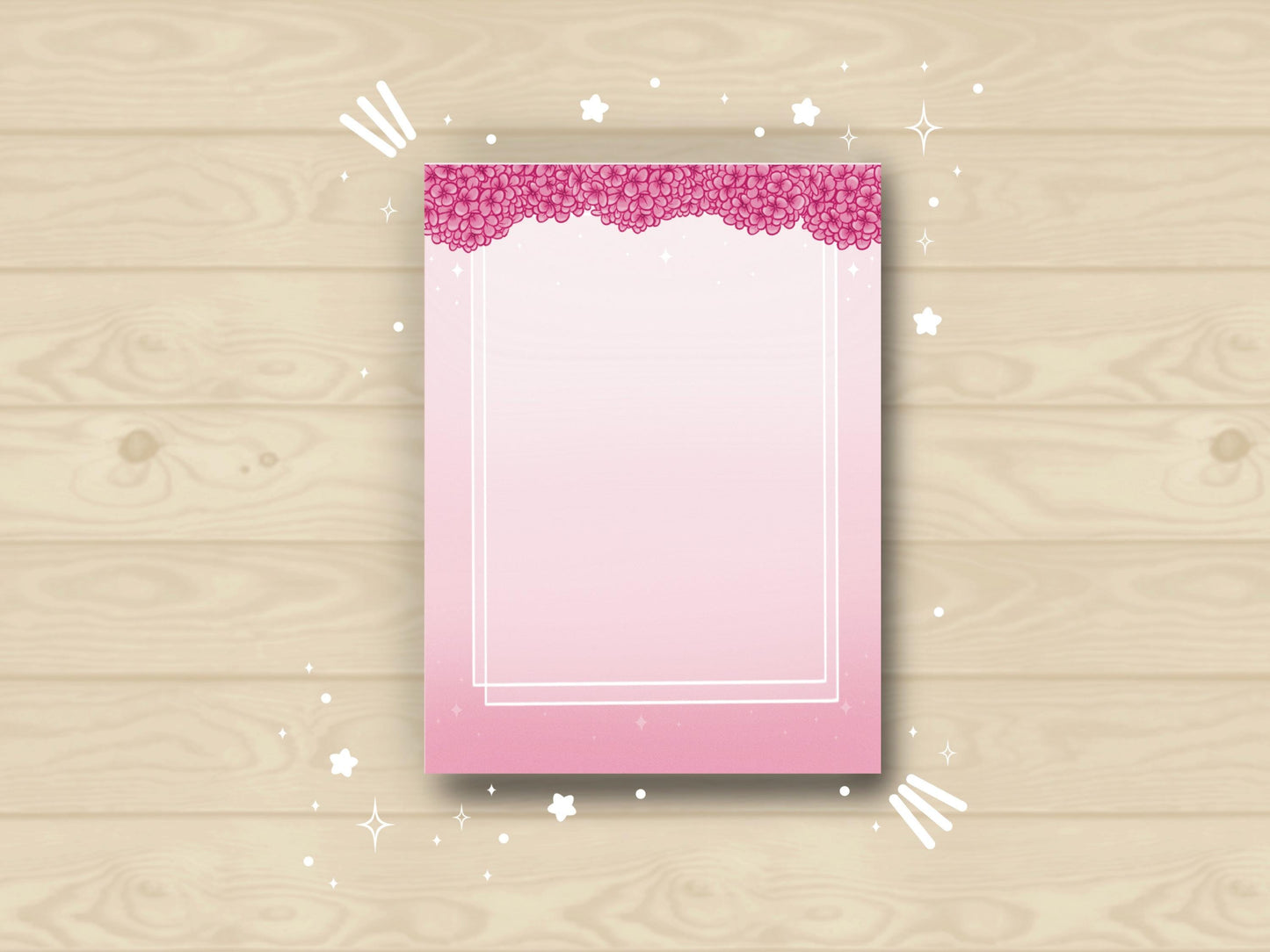 Pink notepad with pink hydrangea flowers bordering the top and a double white border inset from the sides and bottom.