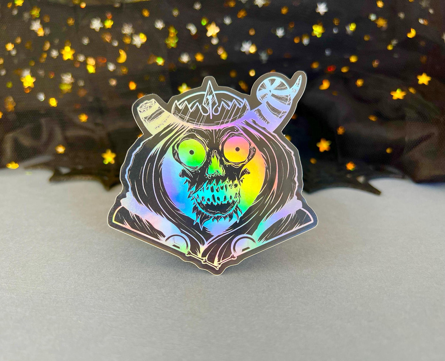 Spooky holographic villain sticker on black vinyl with bold design, approx. 3 inches tall
