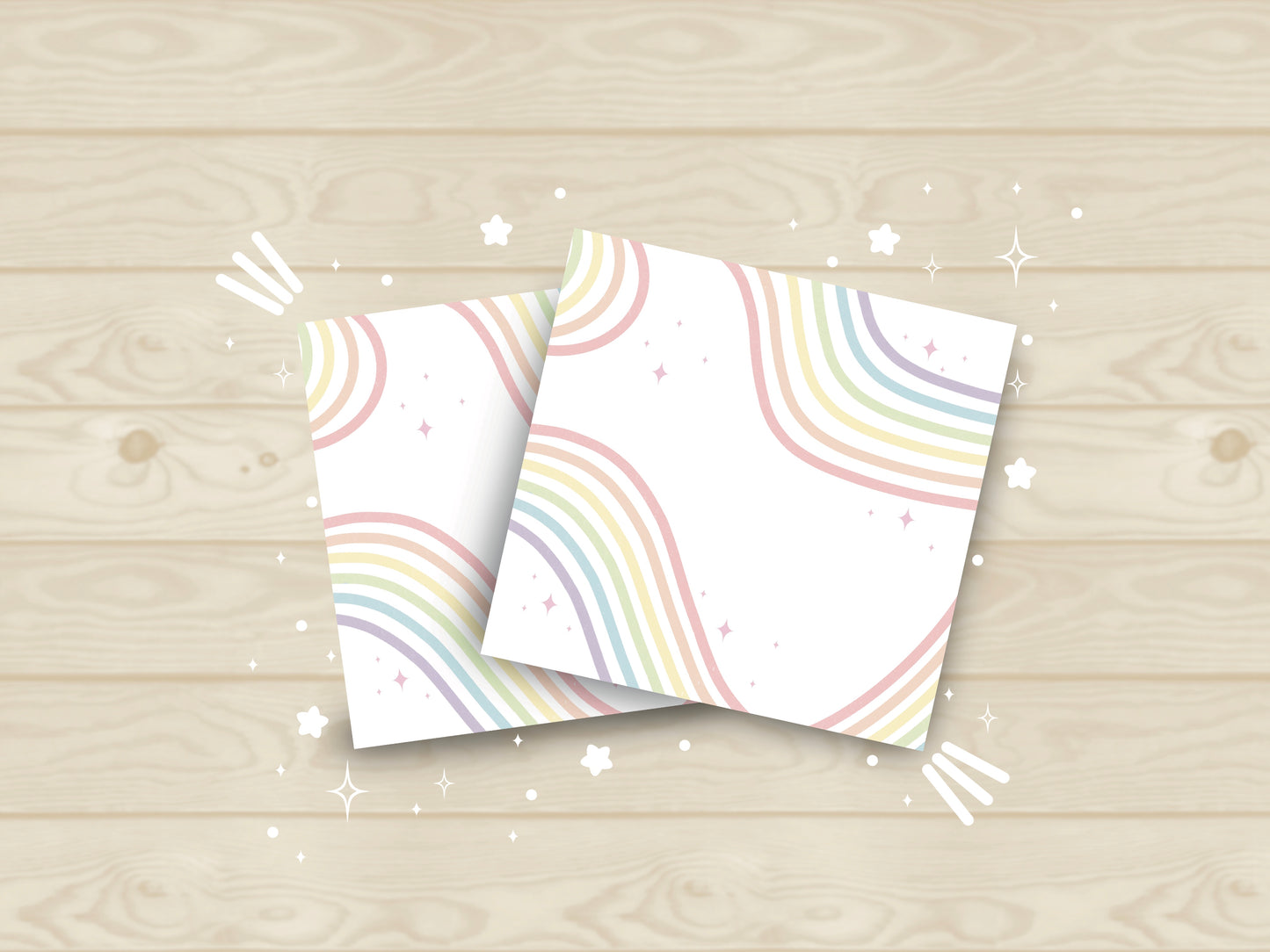 White sticky notes with rainbow ribbons flowing across it and sparkles all around.