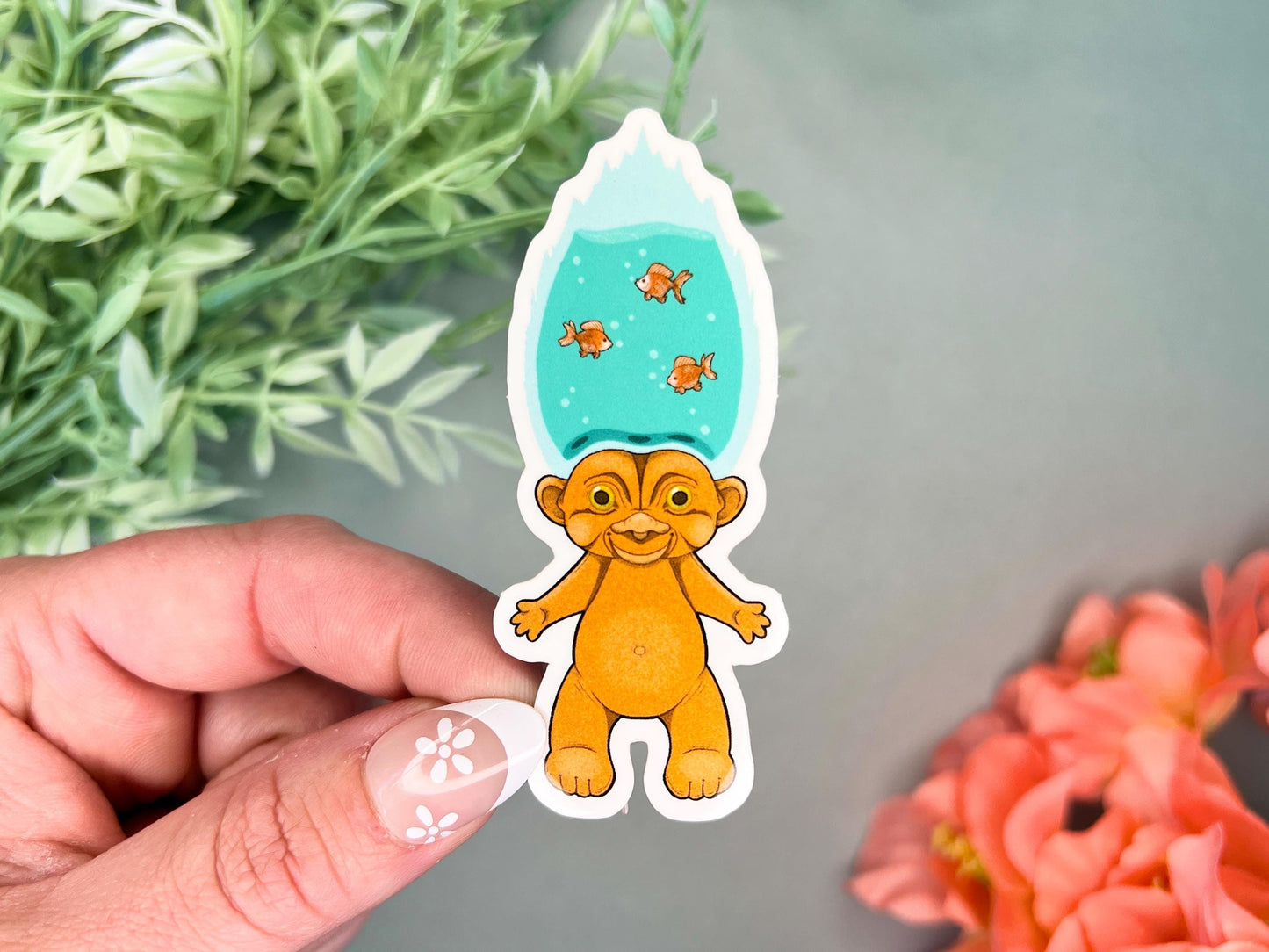 An orange retro hair creature with blue hair made to look like a goldfish bowl.