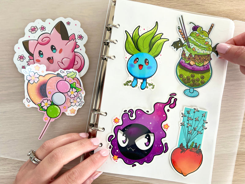 Cute sticker examples being placed inside a sticker collection binder