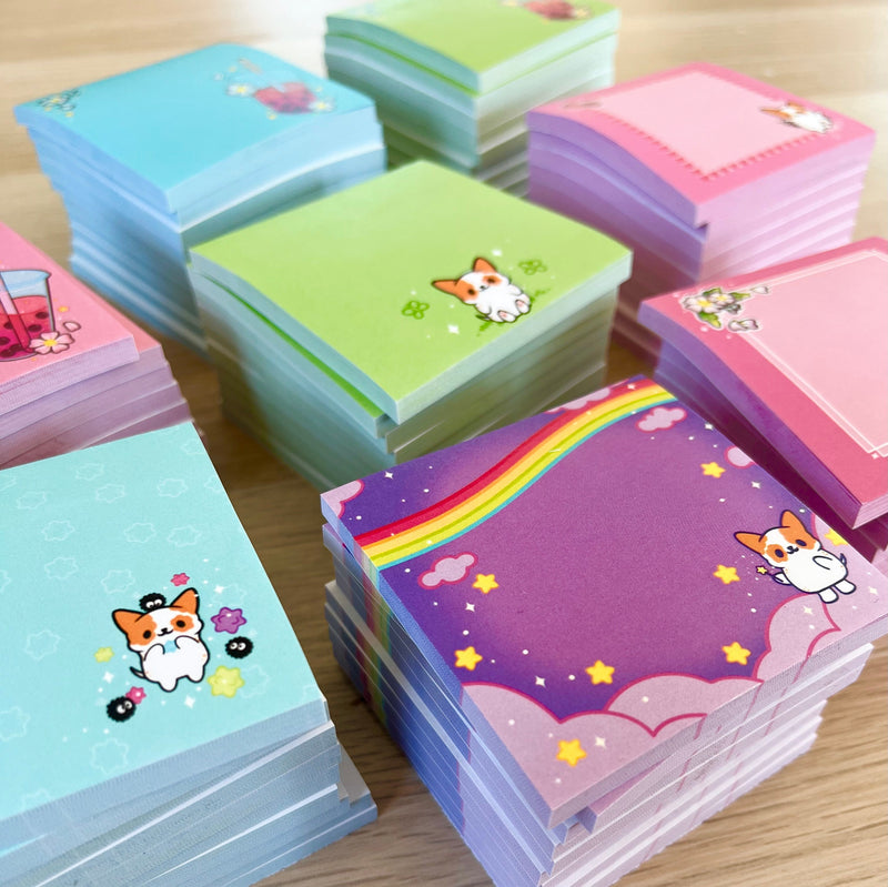 Stack of colorful kawaii sticky notes with cute dog and rainbow designs