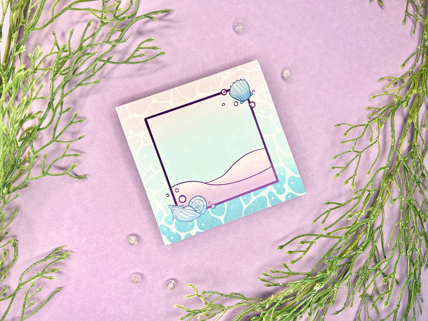 Sticky note pad with pastel seashells and sand designs, measuring 3 in x 3 in, perfect for ocean-themed stationery lovers