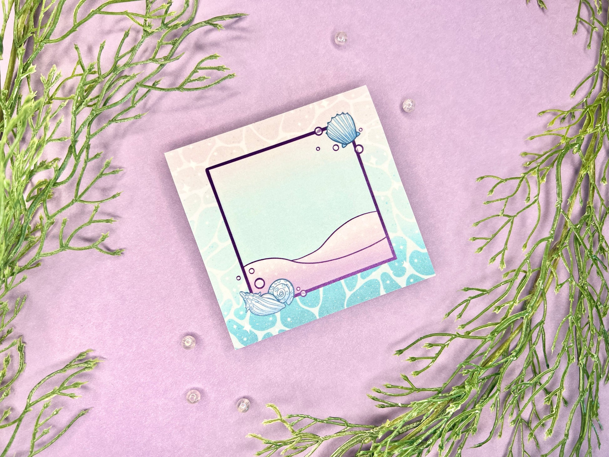 Sticky note pad with pastel seashells and sand designs, measuring 3 in x 3 in, perfect for ocean-themed stationery lovers