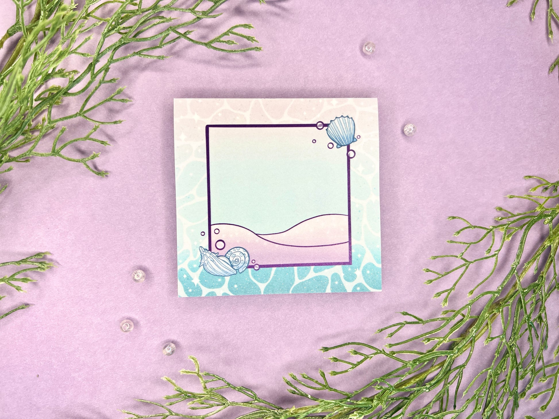 Sticky note pad with pastel seashells and sand designs, measuring 3 in x 3 in, perfect for ocean-themed stationery lovers