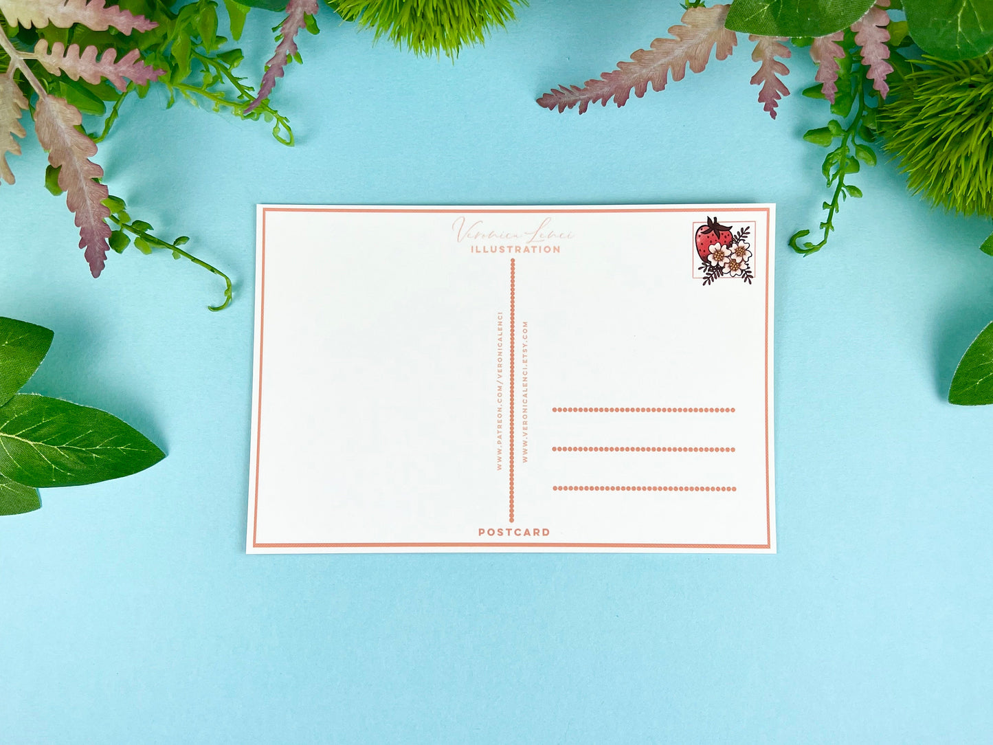 Back of the postcard with a line down the middle, lines on the right side for and address, and a cute strawberry illustration where the stamp would go. 