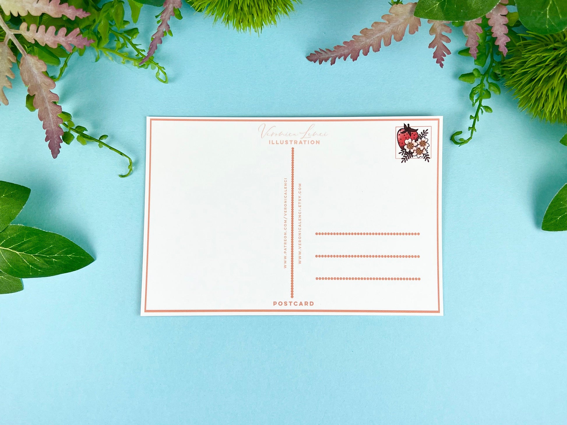 Back of the postcard with a line down the middle, lines on the right side for and address, and a cute strawberry illustration where the stamp would go. 