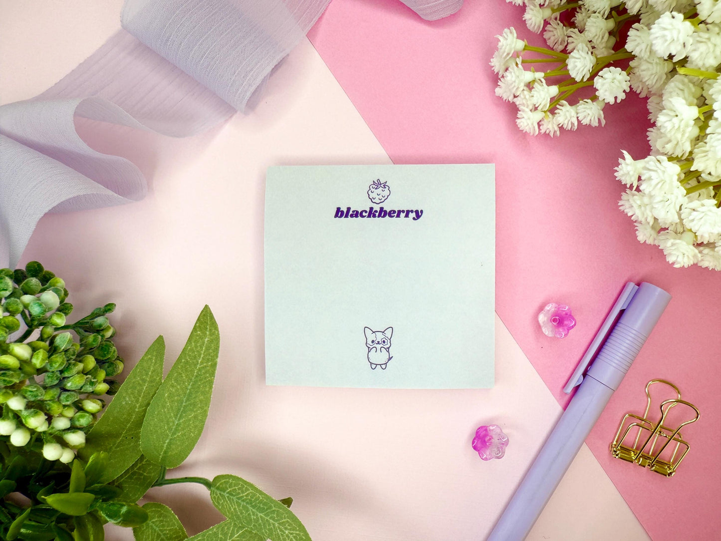 Light purple card with 'blackberry' branding and a cute dog illustration on a pink surface with flowers and a pen.