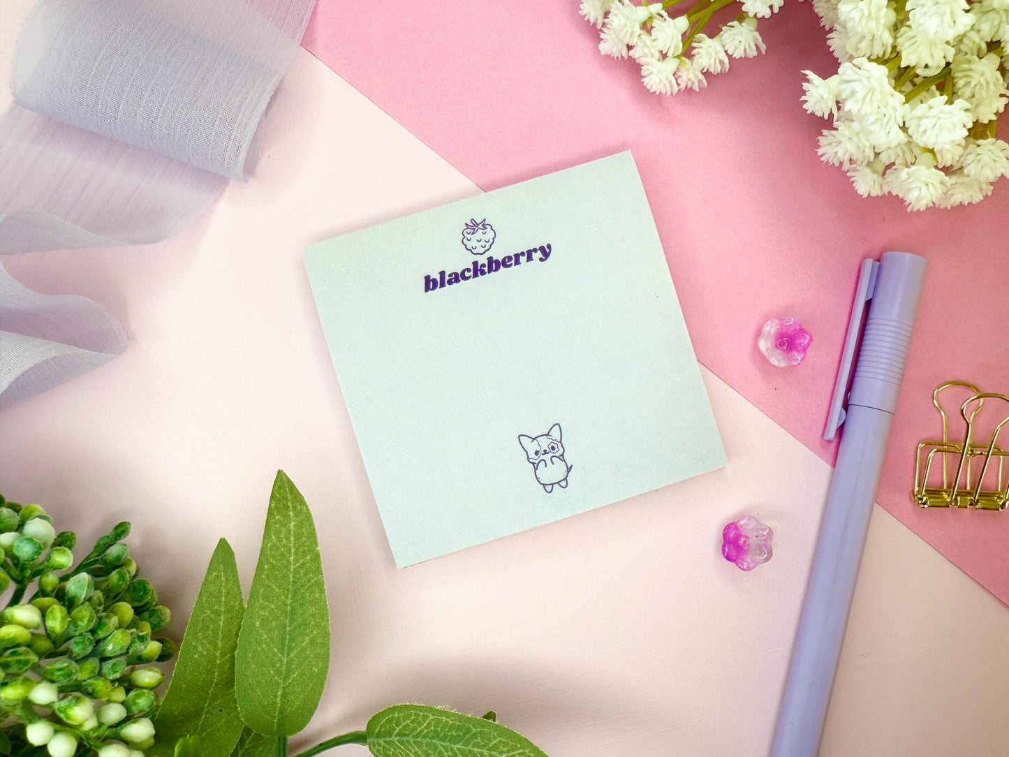 Light purple card with 'blackberry' branding and a cute dog illustration on a pink surface with flowers and a pen.