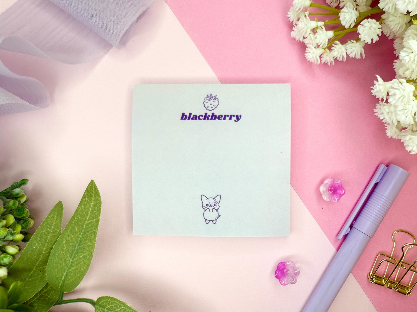 Light purple card with 'blackberry' branding and a cute dog illustration on a pink surface with flowers and a pen.