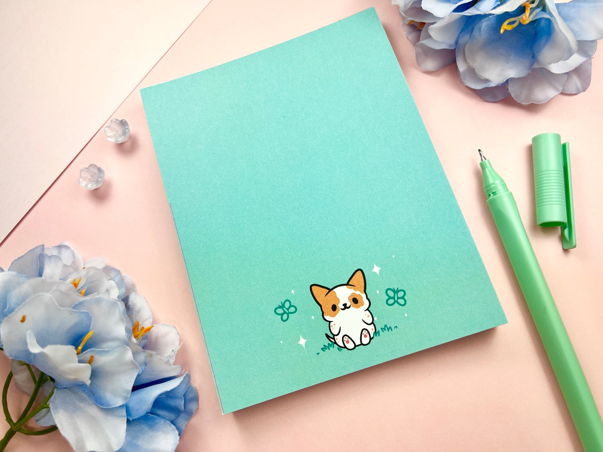 Kawaii notepad featuring a dog surrounded by butterflies in a blue pastel color