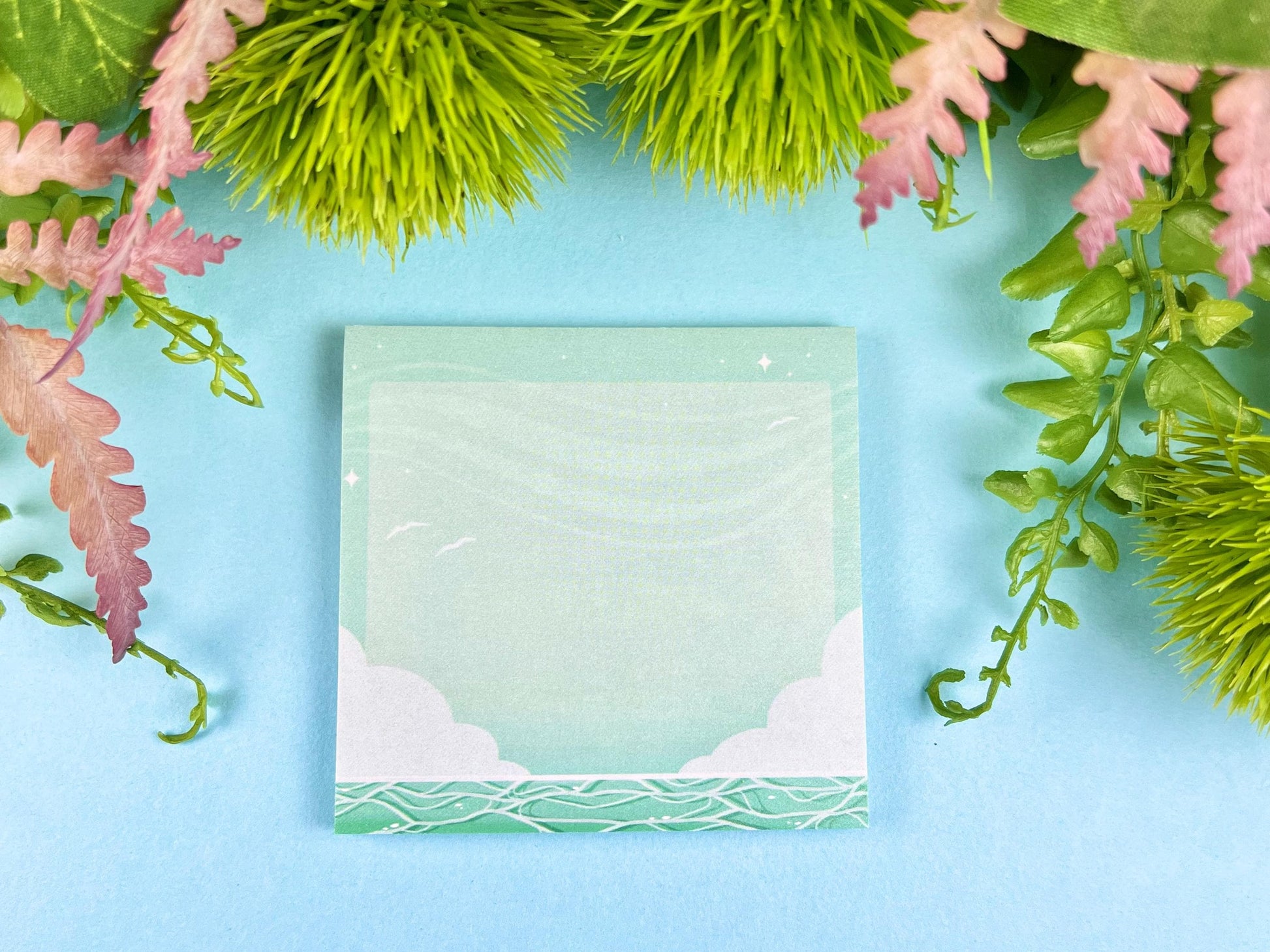 Kawaii sticky note pad with cloudy ocean design in green and blue tones