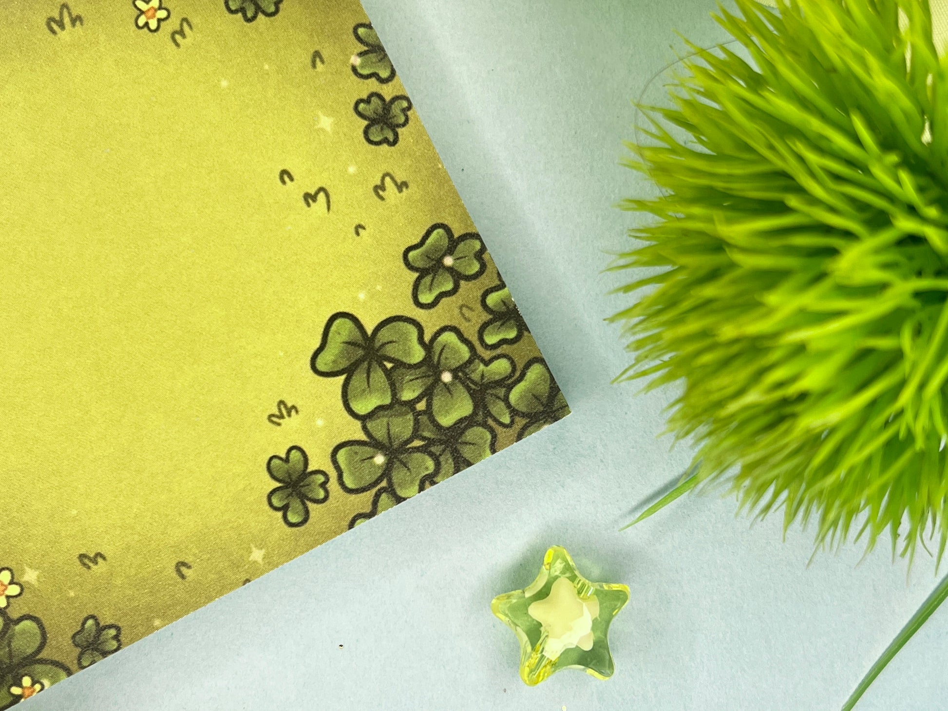 Green sticky notes of a field of green clovers, grass, and yellow flowers.