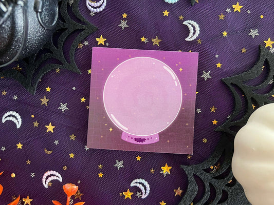 Purple and black sticky notes with a large purple crystal ball with smoke placed in the middle.