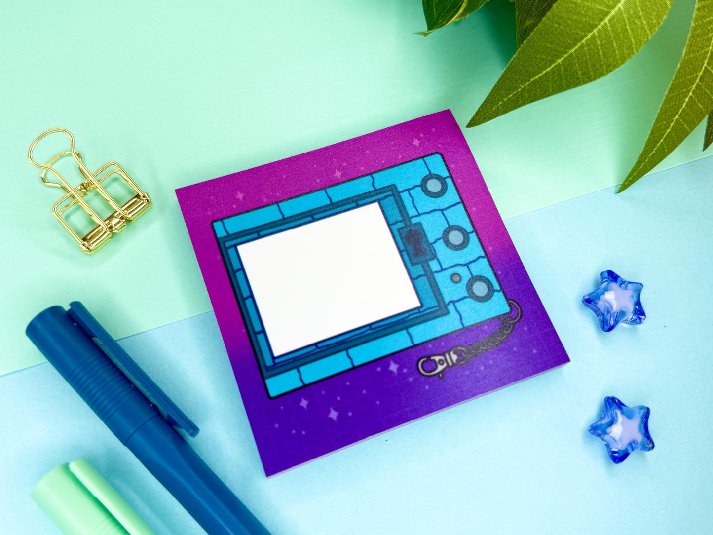 Digital blue pet game console keychain with a pink and purple background.