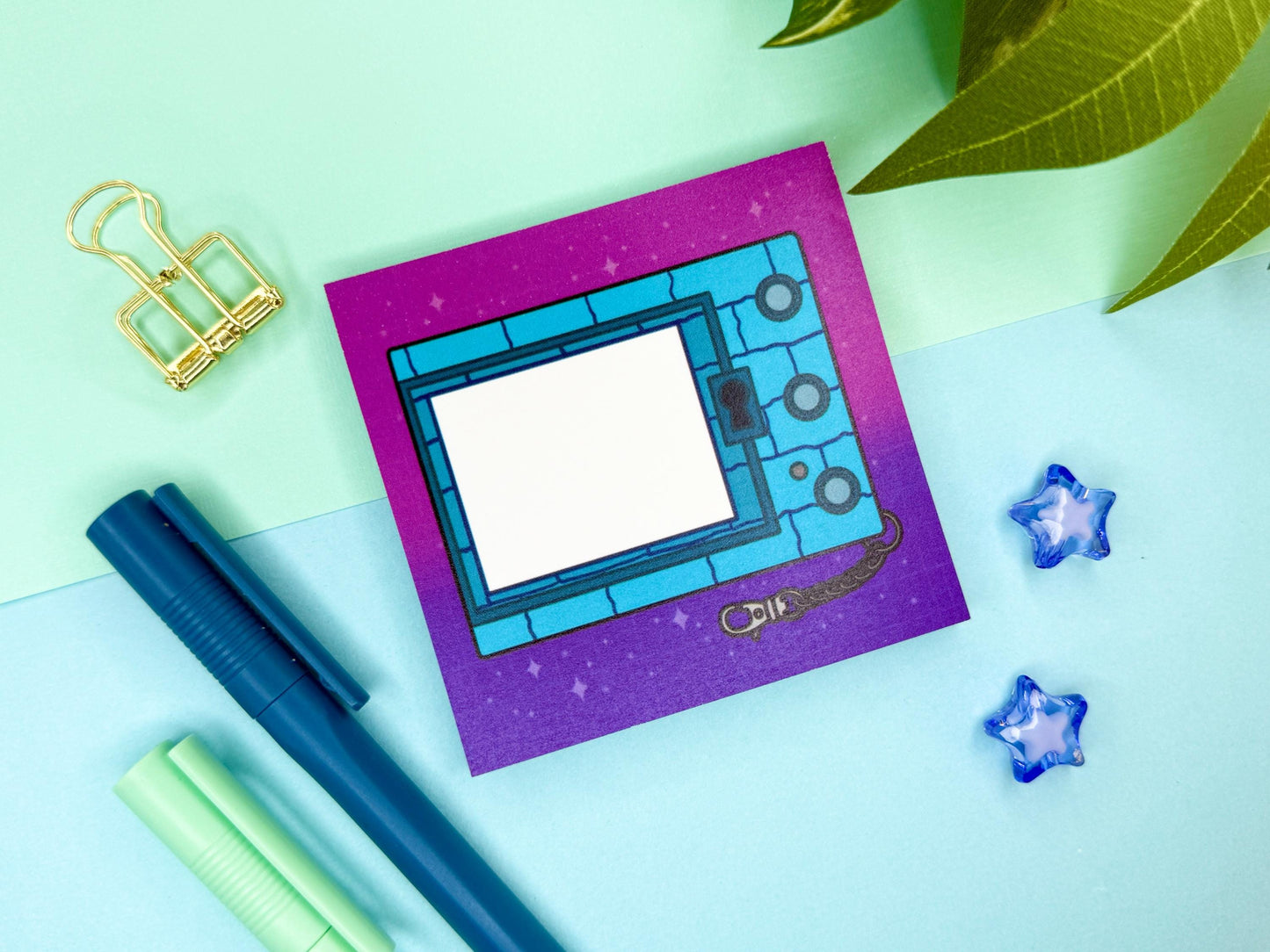 Digital blue pet game console keychain with a pink and purple background.