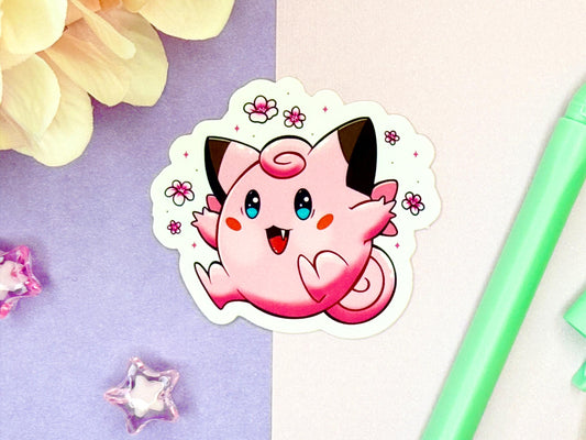 Cute pink animal fairy sticker with brown tipped ears and blue eyes surrounded by pink flowers.