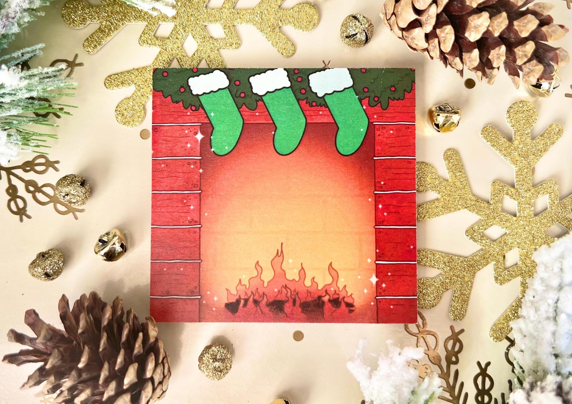 Holiday themed sticky notes of a red bricked fireplace, green hung stockings and green garland on top, with a log fire lit at the bottom.