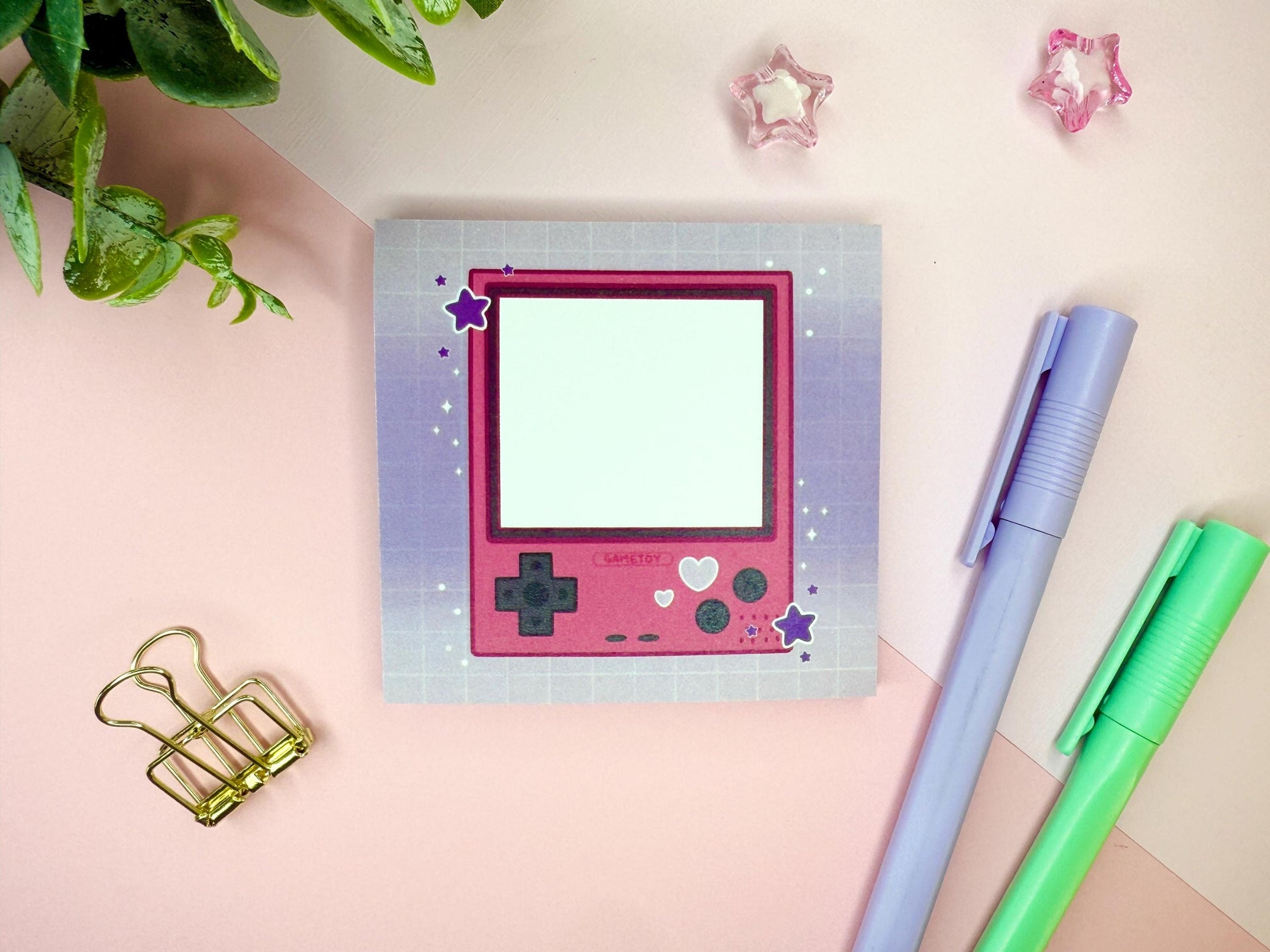 Pink game toy console with a purple background.