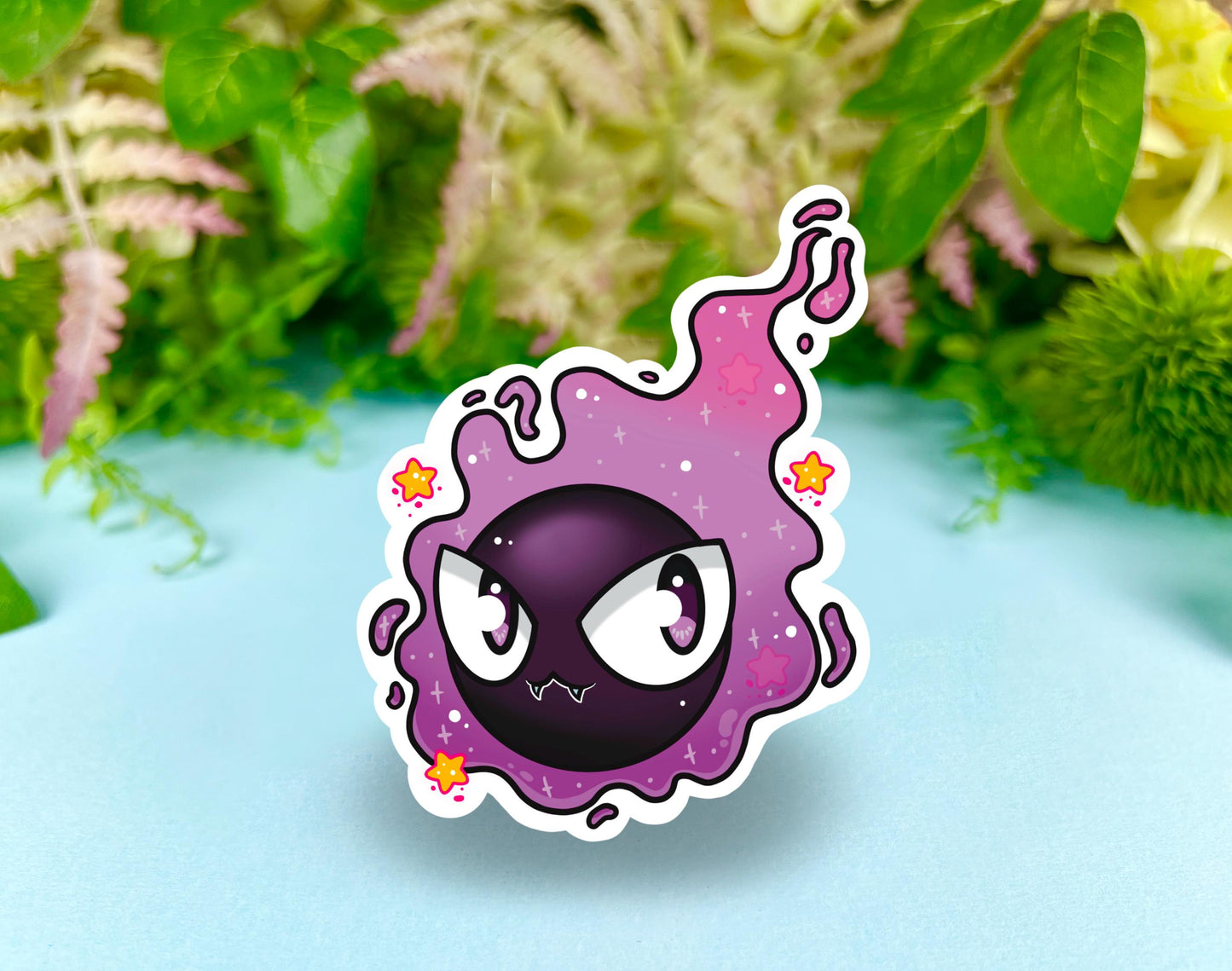 Purple and black ghost cloud design with large eyes and sparkles.