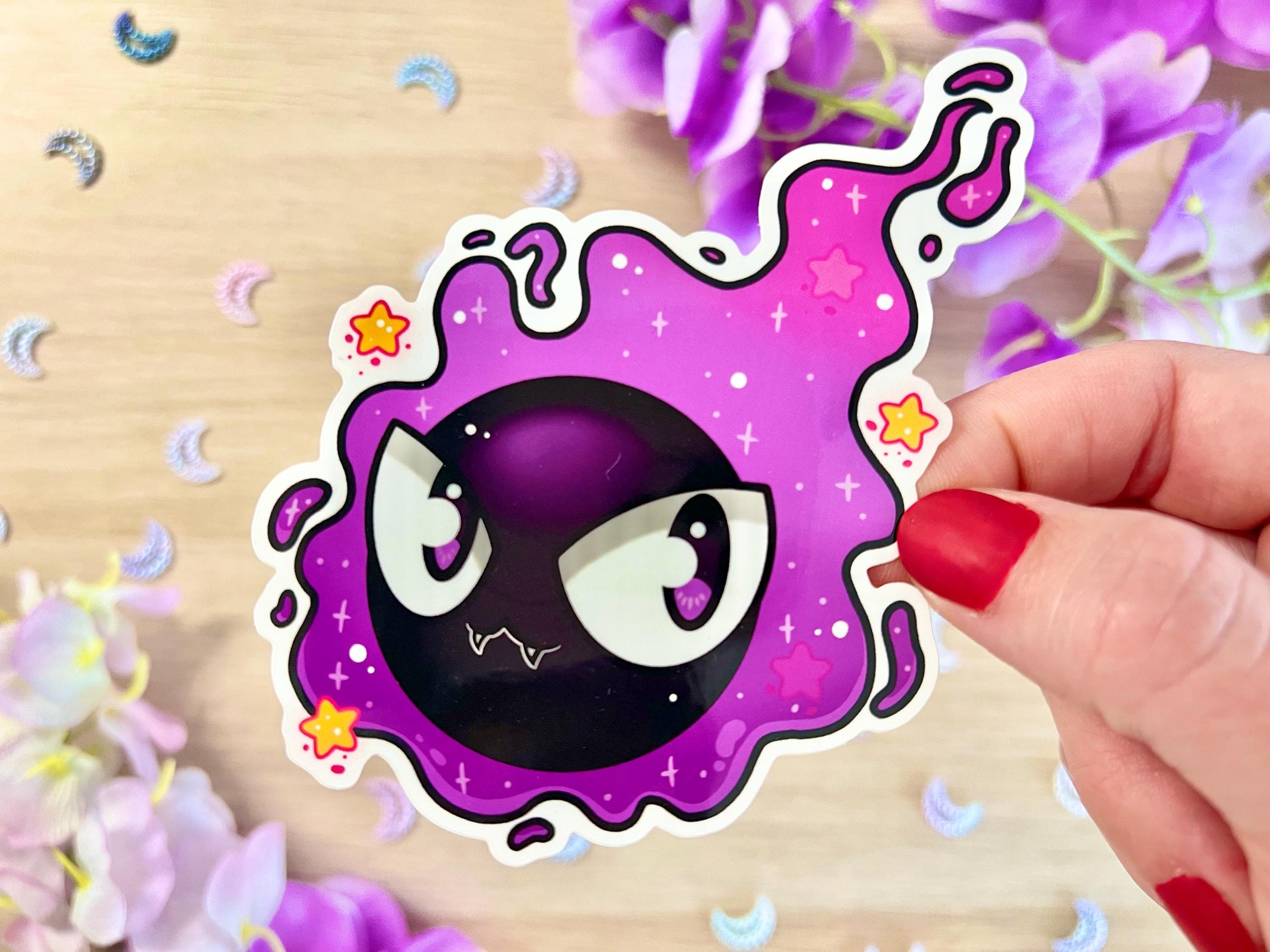 Purple and black ghost cloud design with large eyes and sparkles.