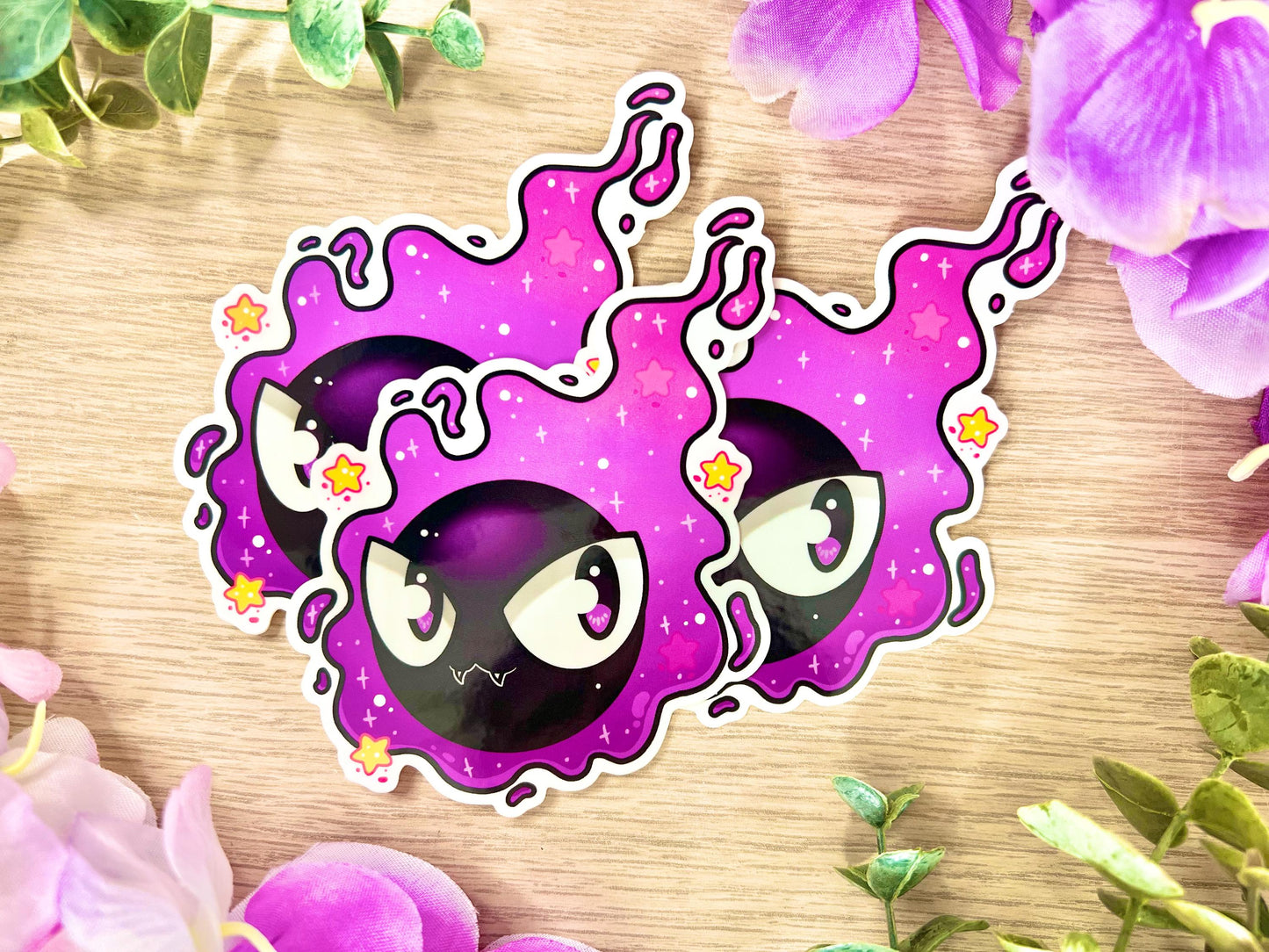 Purple and black ghost cloud design with large eyes and sparkles.