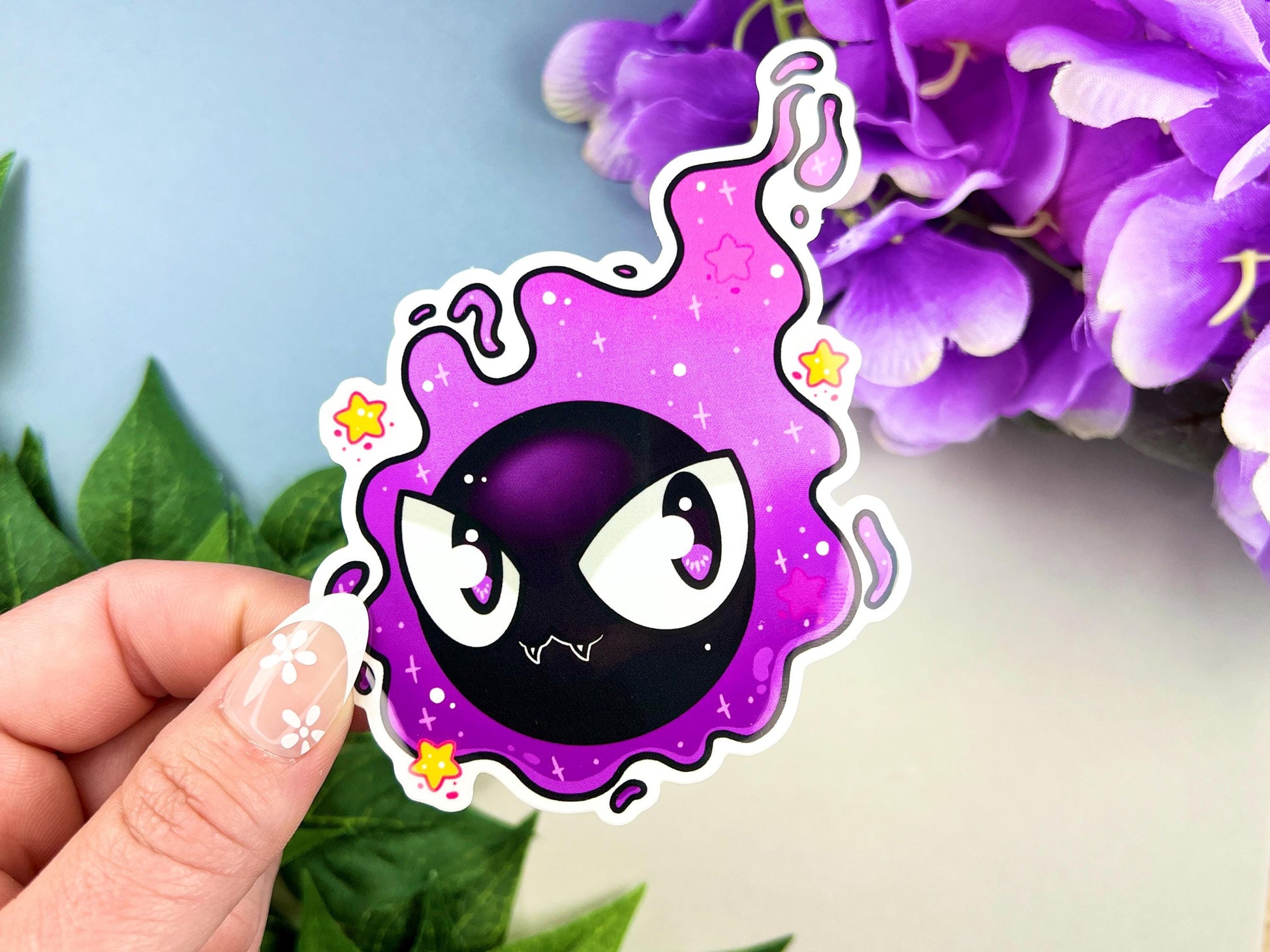 Purple and black ghost cloud design with large eyes and sparkles.