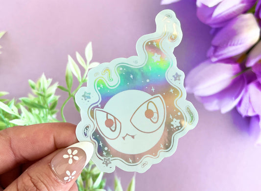 White holographic vinyl sticker of a kawaii ghost cloud with pastel Halloween aesthetic