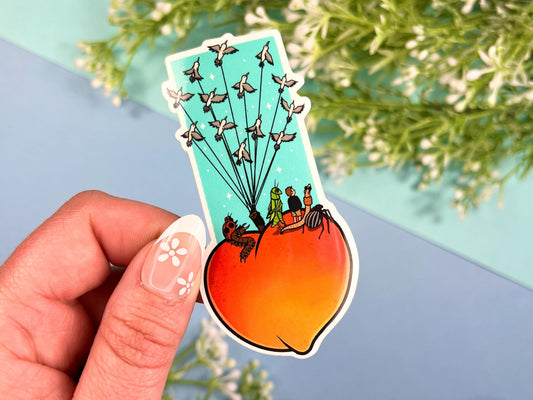 Sticker of a giant peach with people and bugs being carried by birds on a colorful blue background.