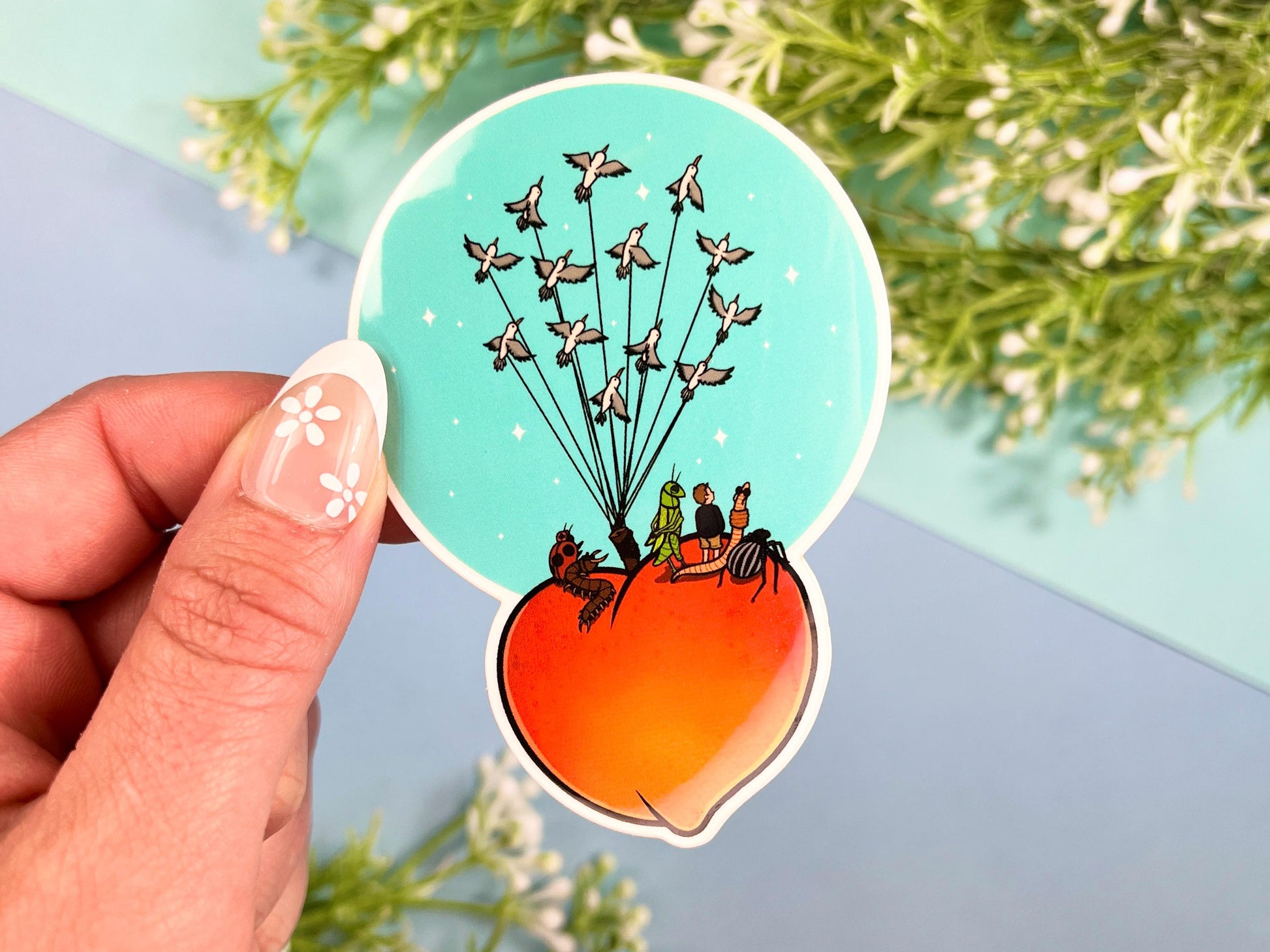Sticker of a giant peach with people and bugs being carried by birds on a colorful blue background.