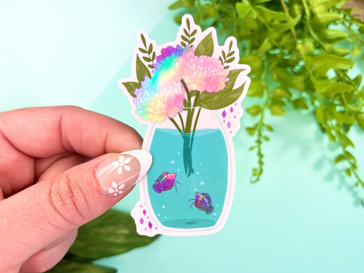 A vase filled with pink holographic Peony flowers and has water with purple holographic Gourami fish inside.