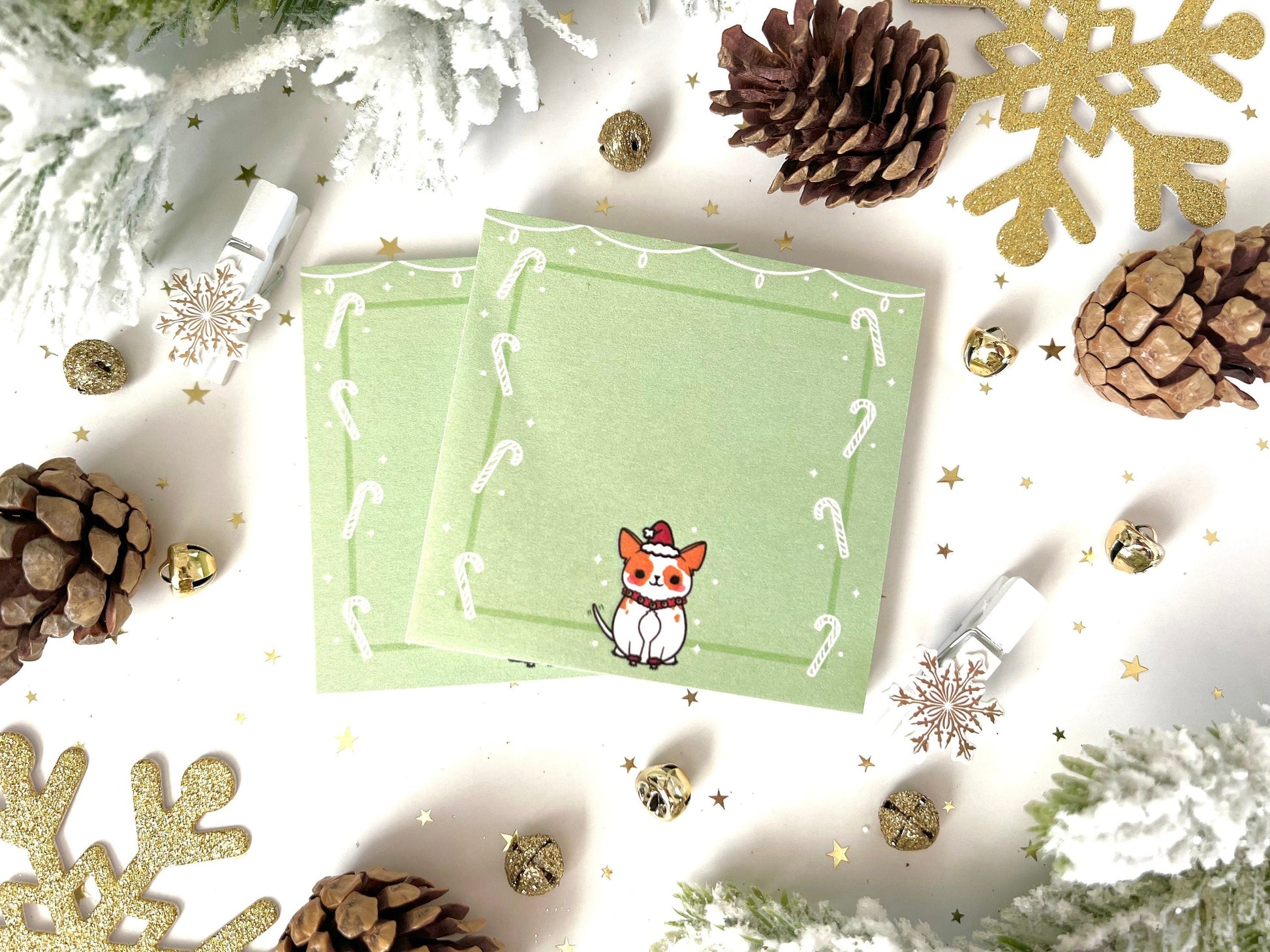 Green sticky notes with white string lights at the top, white candy canes along the sides, and a cute dog wearing a Santa Hat on the bottom.