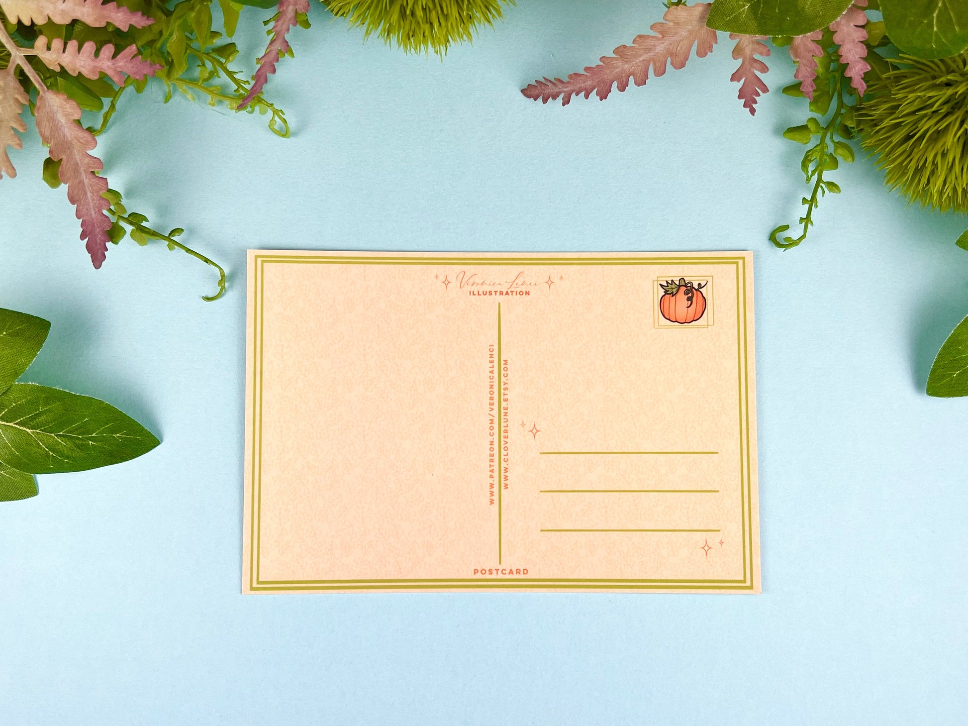 Back of the postcard with a line down the middle, lines on the right side for and address, and a cute pumpkin illustration where the stamp would go. 