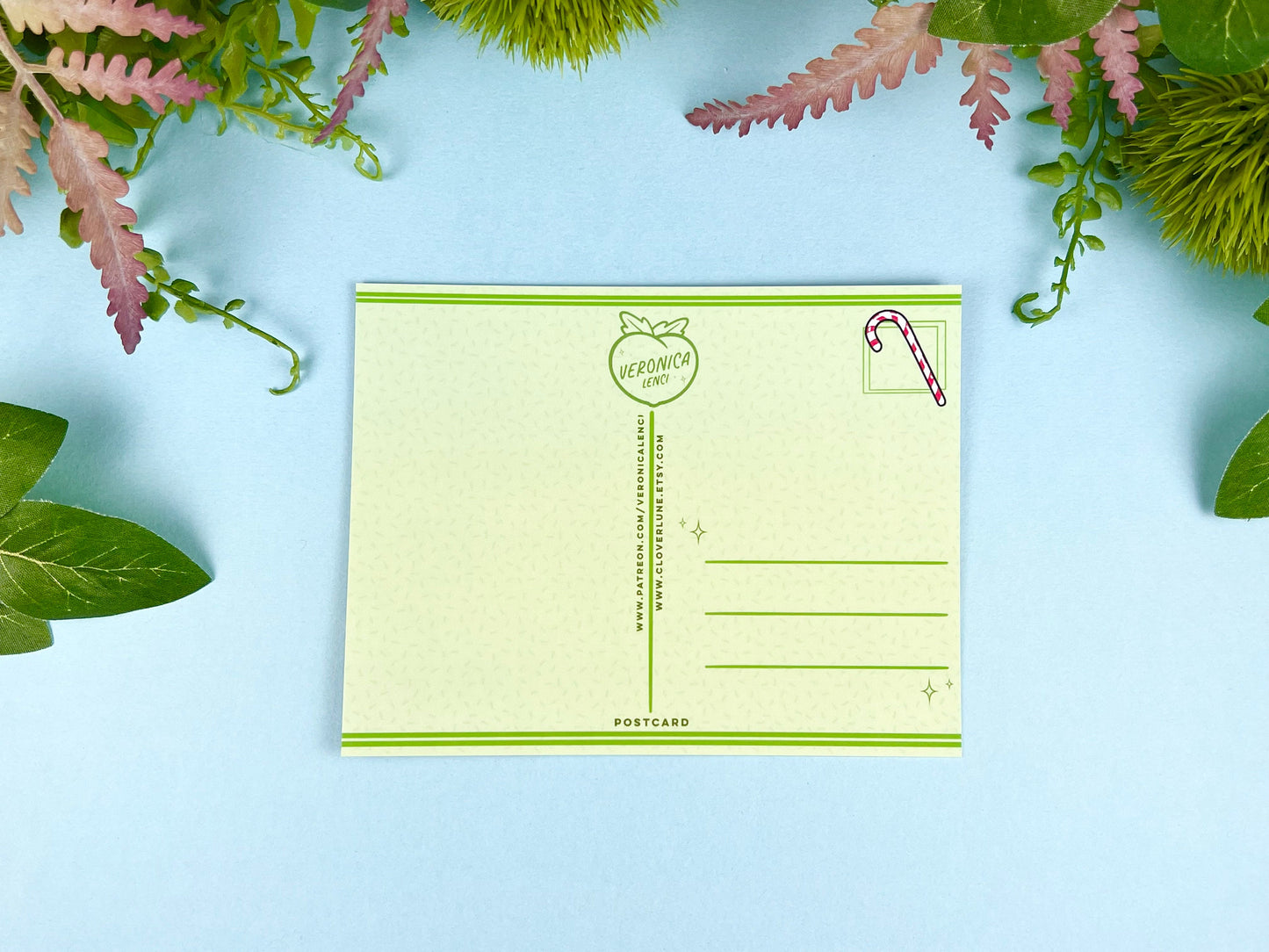 Back of the postcard with a line down the middle, lines on the right side for and address, and a cute candy cane illustration where the stamp would go. 