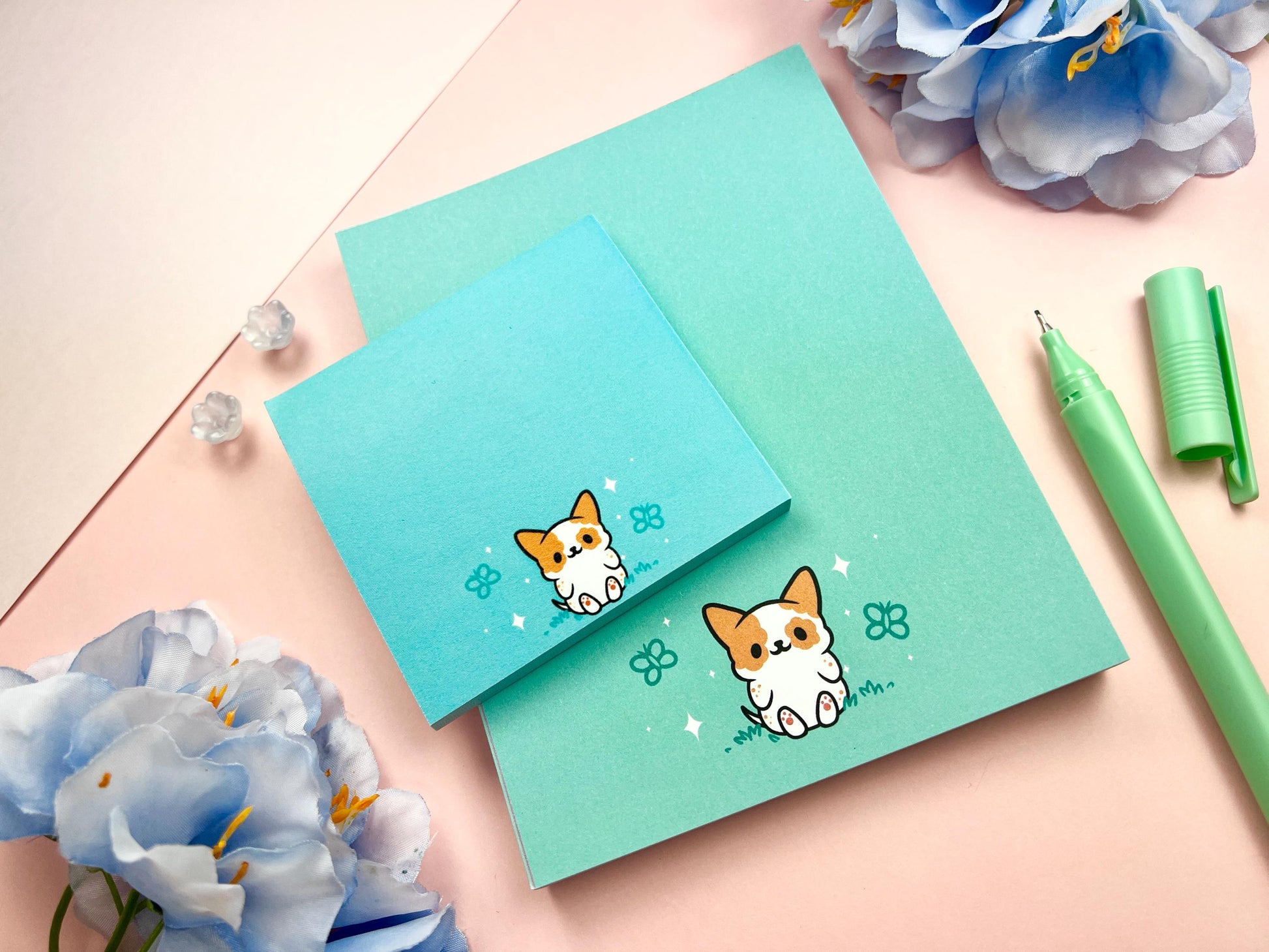 A sticky note and notepad gift set with a dog illustration on a blue background surrounded by butterflies.
