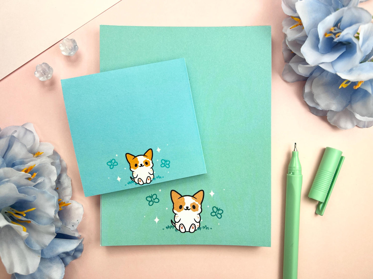 A sticky note and notepad gift set with a dog illustration on a blue background surrounded by butterflies.
