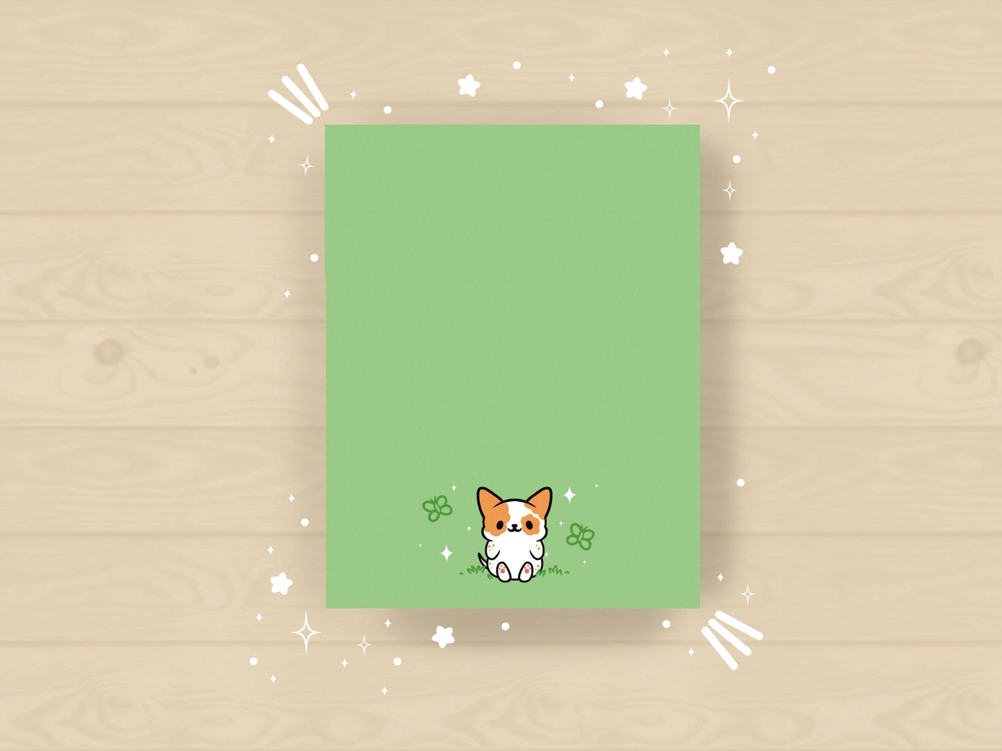 Light green notepad with an illustration of a cute dog sitting among the butterflies.