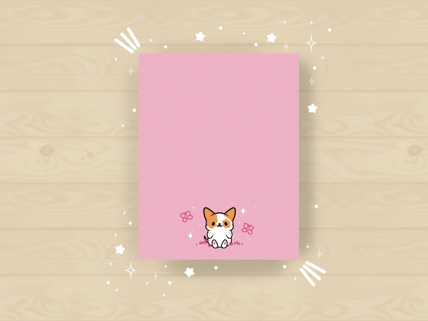 Pink notepad with an illustration of a cute dog sitting among the butterflies.