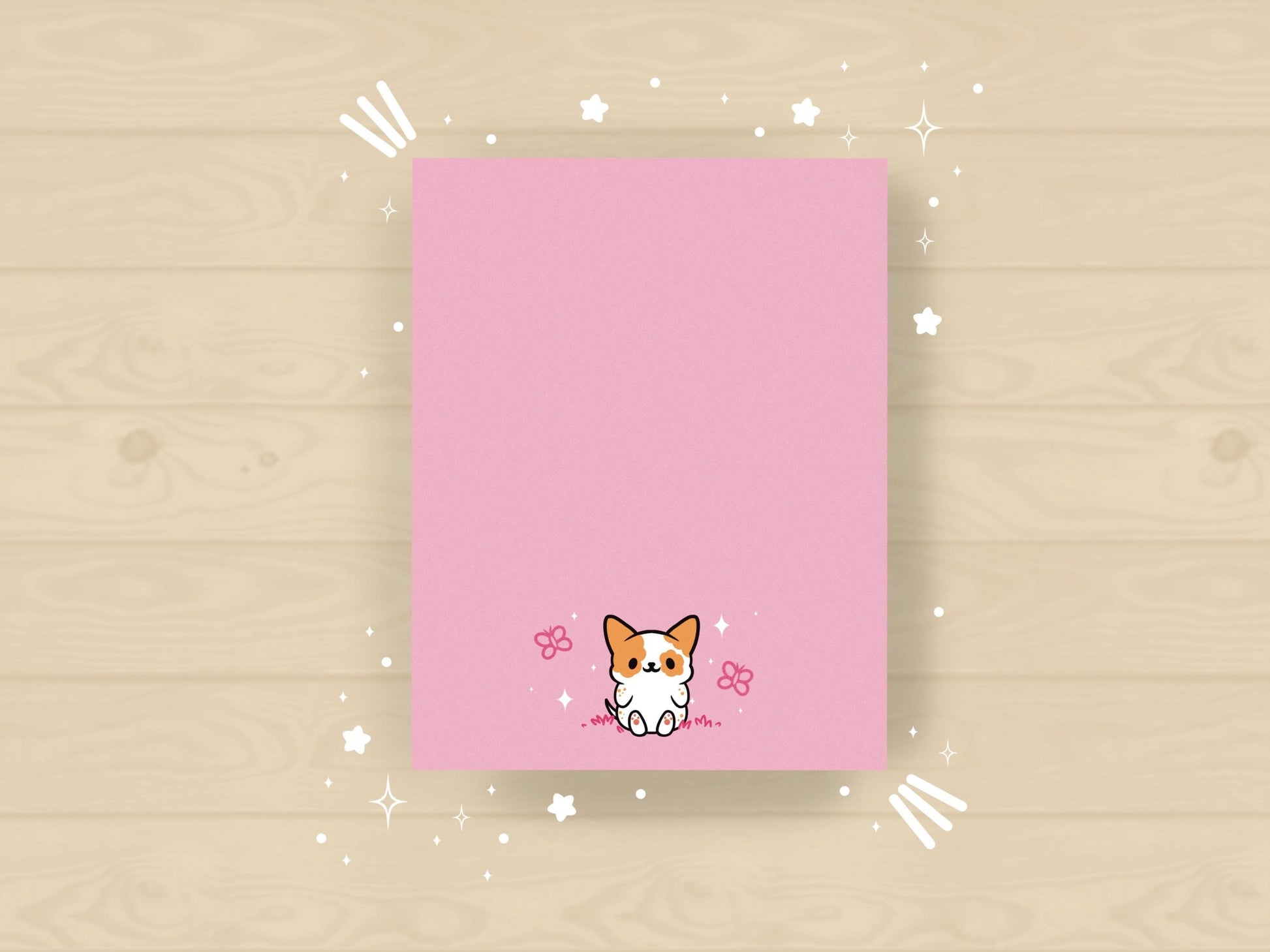 Pink notepad with an illustration of a cute dog sitting among the butterflies.