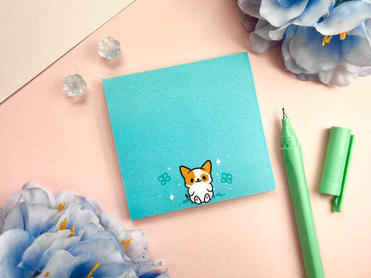 Turquoise sticky note with a cute dog sitting among butterflies.