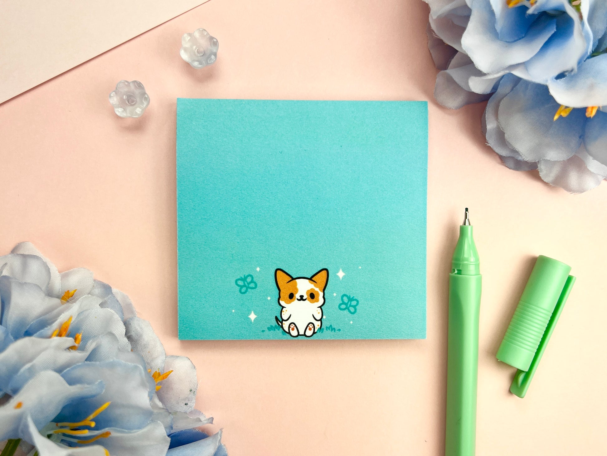 Turquoise sticky note with a cute dog sitting among butterflies.