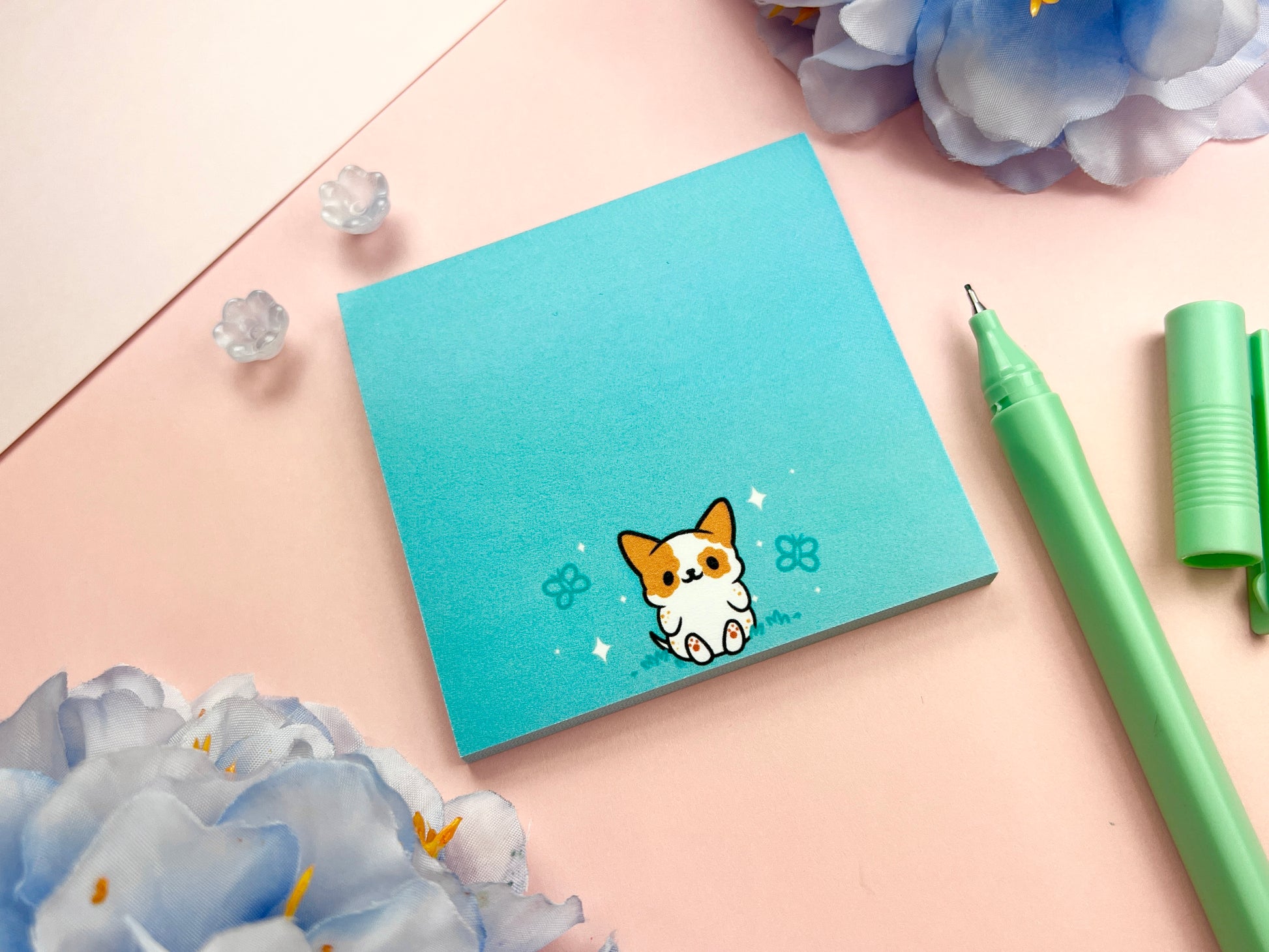 Turquoise sticky note with a cute dog sitting among butterflies.