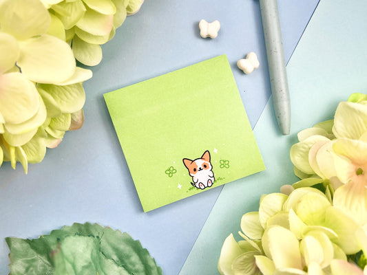 Sticky note with a dog illustration on a green background surrounded by butterflies
