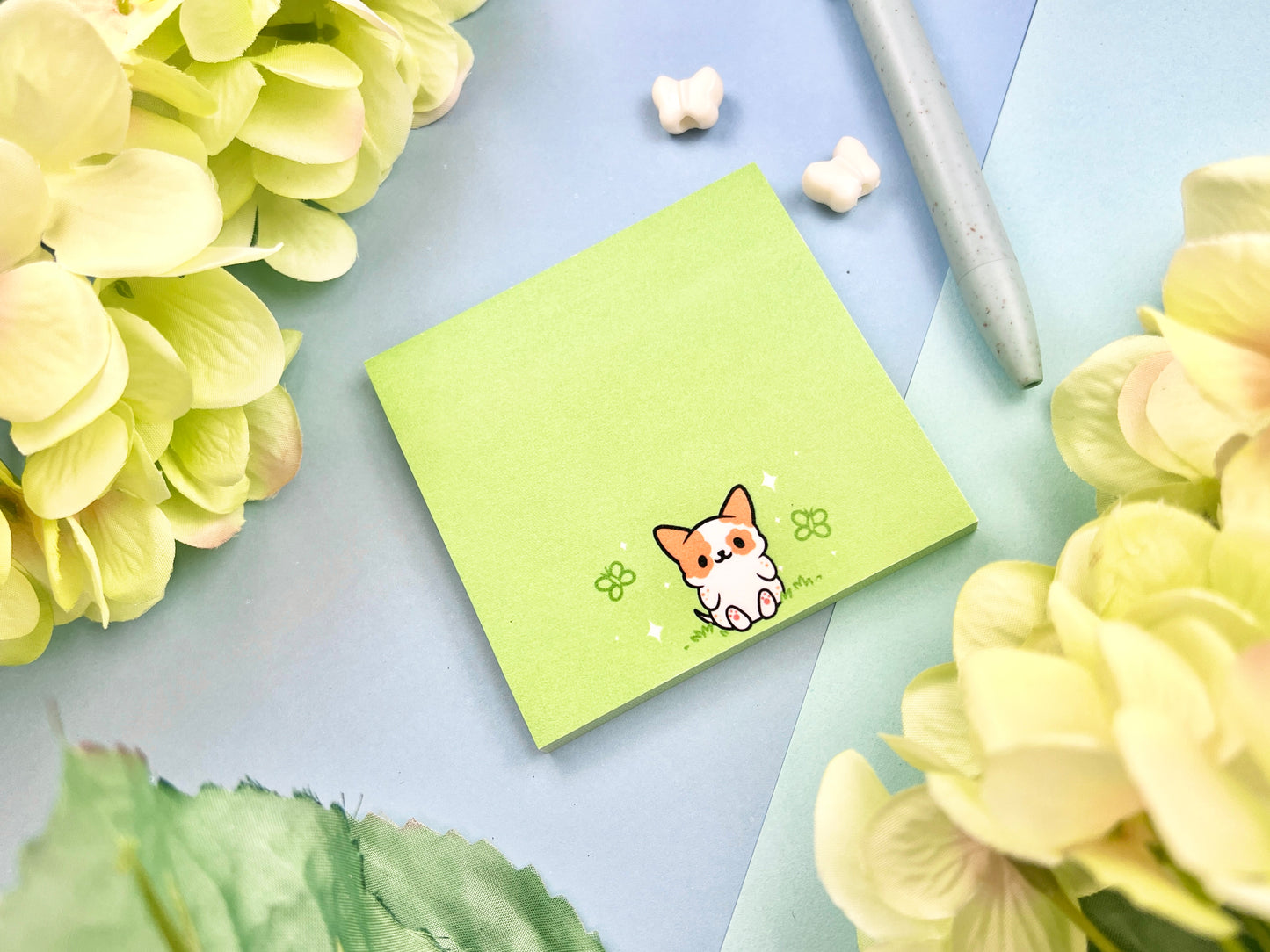 Sticky note with a dog illustration on a green background surrounded by butterflies.