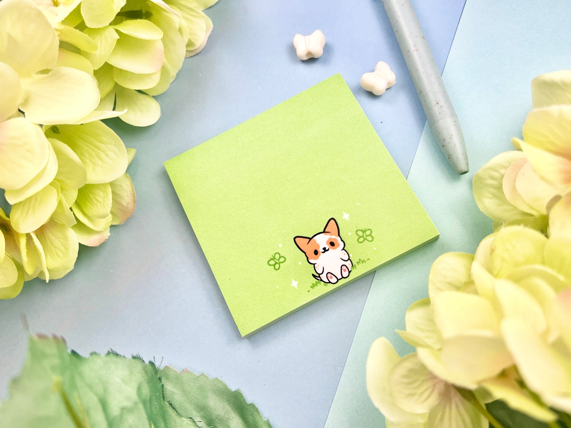 Sticky note with a dog illustration on a green background surrounded by butterflies.