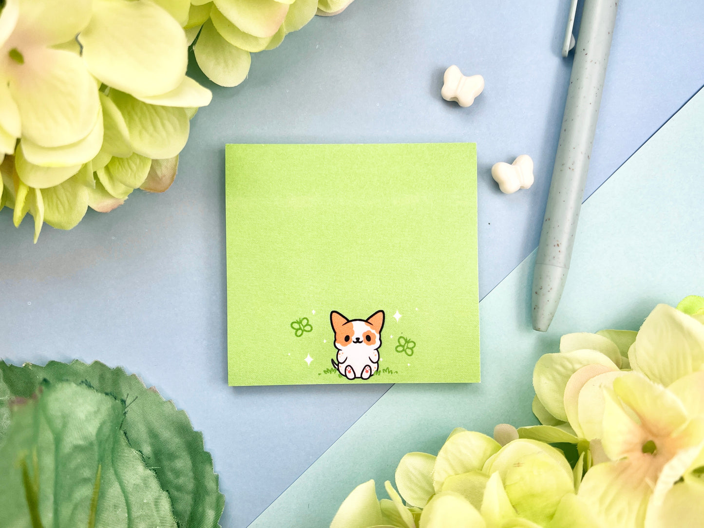 Sticky note with a dog illustration on a green background surrounded by butterflies